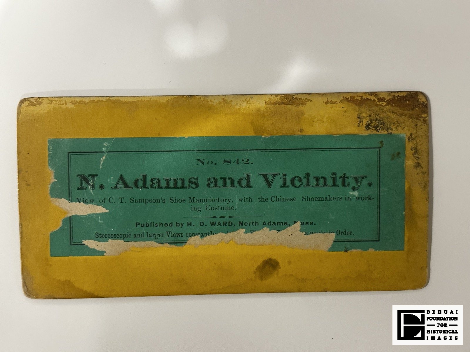 TFA-CA-106 — Verso: the printed green label, torn at the right with loss of text.