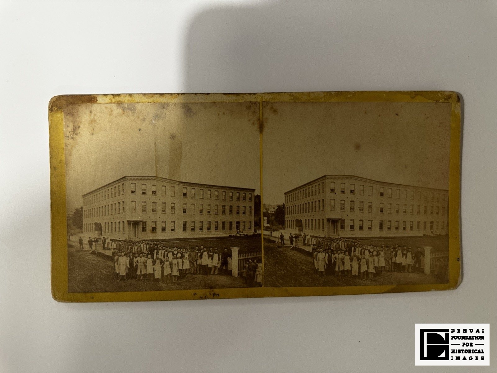 TFA-CA-106 — Mount face: the factory with the workforce lined up across its frontage.