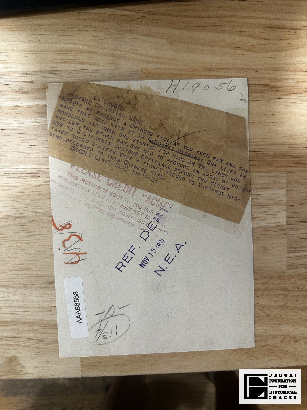 TFA-CA-118 — Verso: the pasted ACME caption slug, the NEA reference stamp of 19 November 1931, and later annotations.